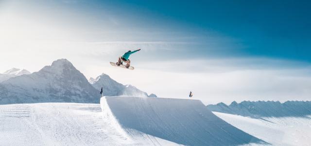 snowboarder in air above jump